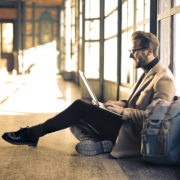 Man sitting on the ground with his laptop